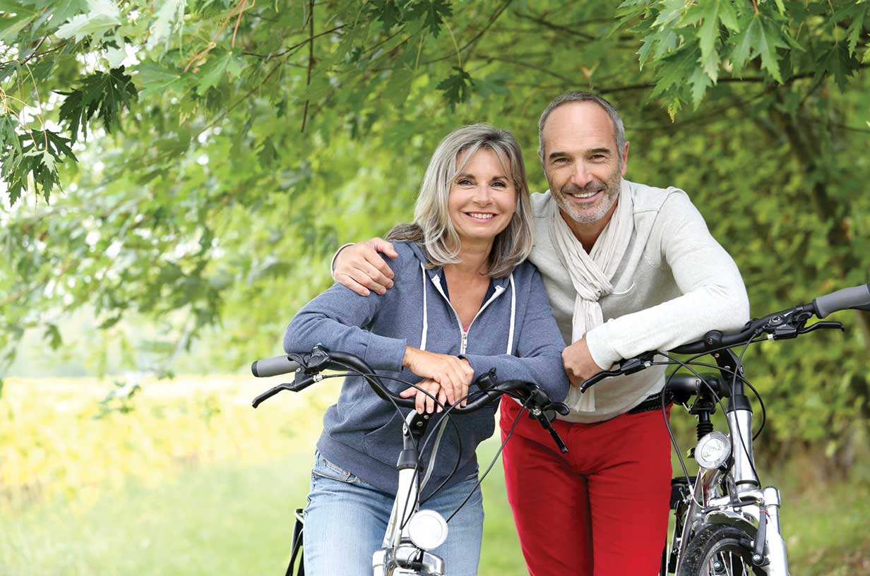 man and woman outside next to a bike